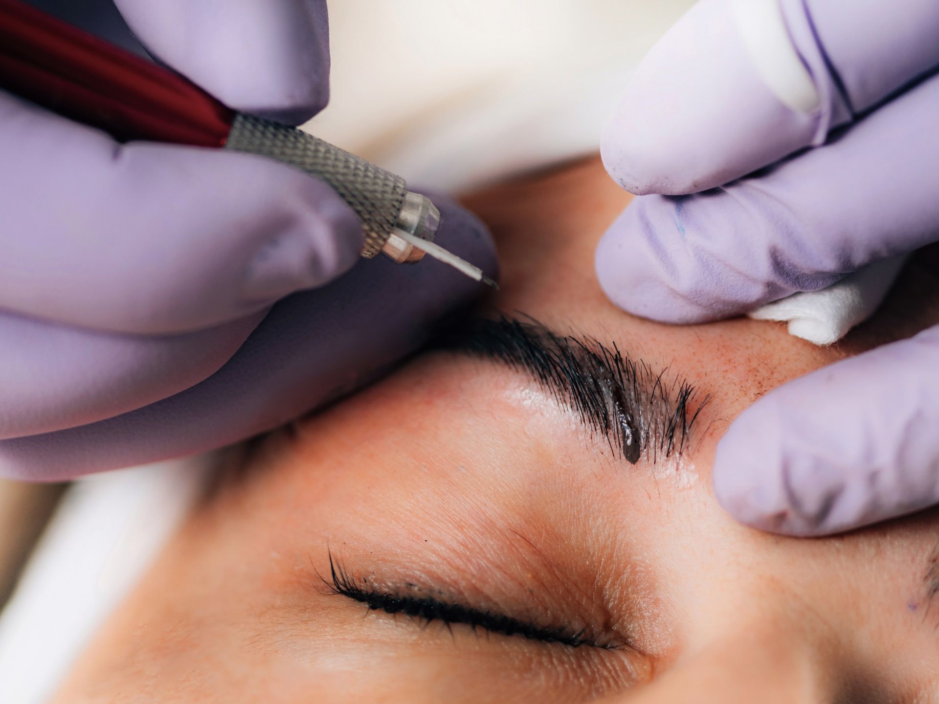 Permanent Makeup Artist creating hair-like strokes using Microblading Needle and Pigment.