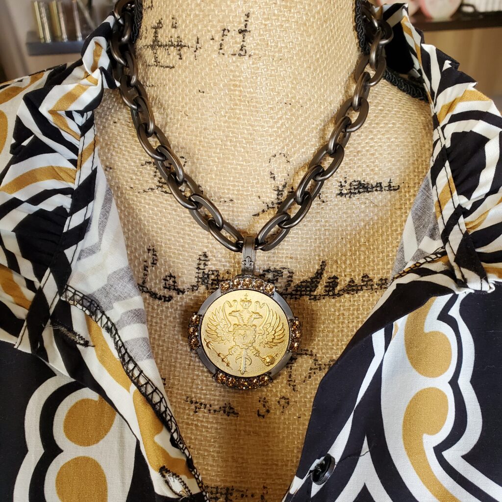 french gold medallion with black chain
